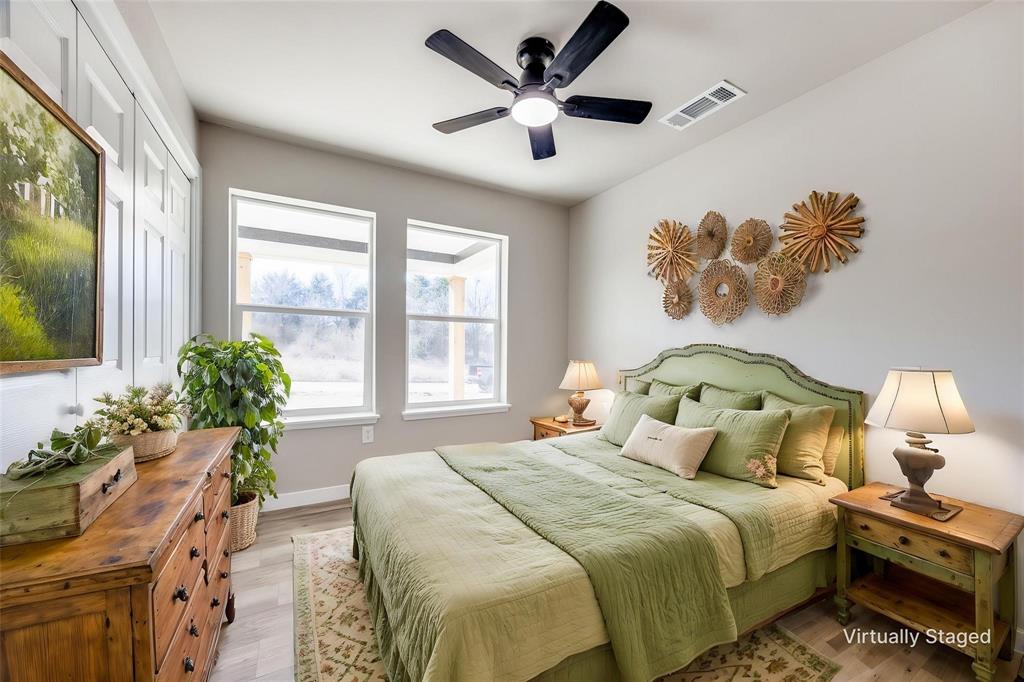 224 West Cardinal Street Ector, TX 75439 - Photo 7 of 7 a bedroom with a bed and a chandelier