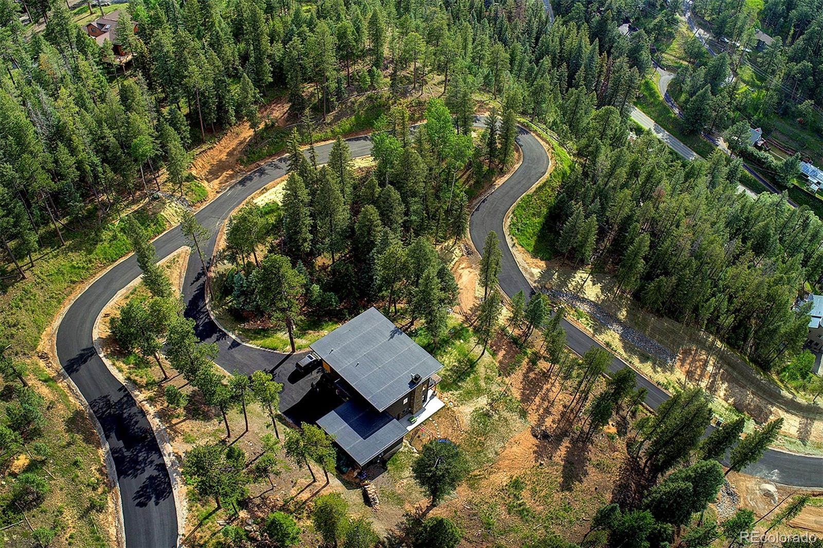 6855 Lynx Lair Road Evergreen, CO 80439 - Photo 14 of 14 an aerial view of a house with swimming pool and outdoor space