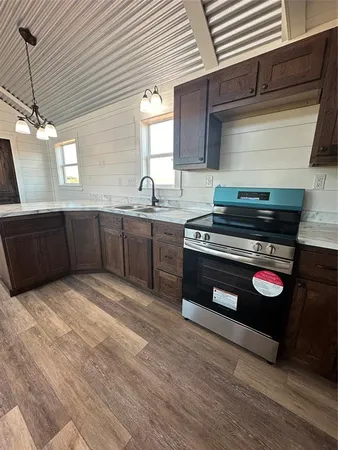 a kitchen with wooden cabinets and a stove