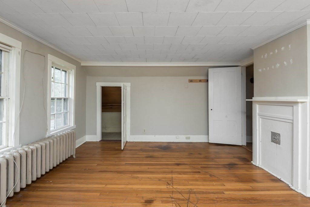 716 High Street Hanson, MA 02341 - Photo 11 of 21 a view of an empty room with wooden floor and a window