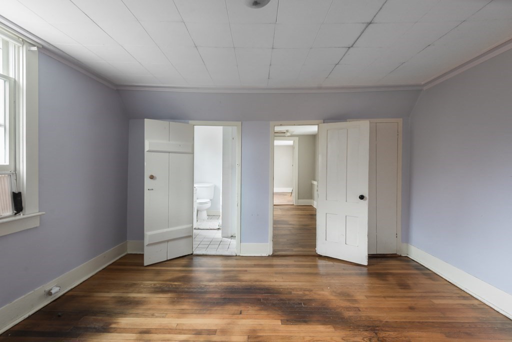 716 High Street Hanson, MA 02341 - Photo 14 of 21 a view of an empty room with wooden floor and window