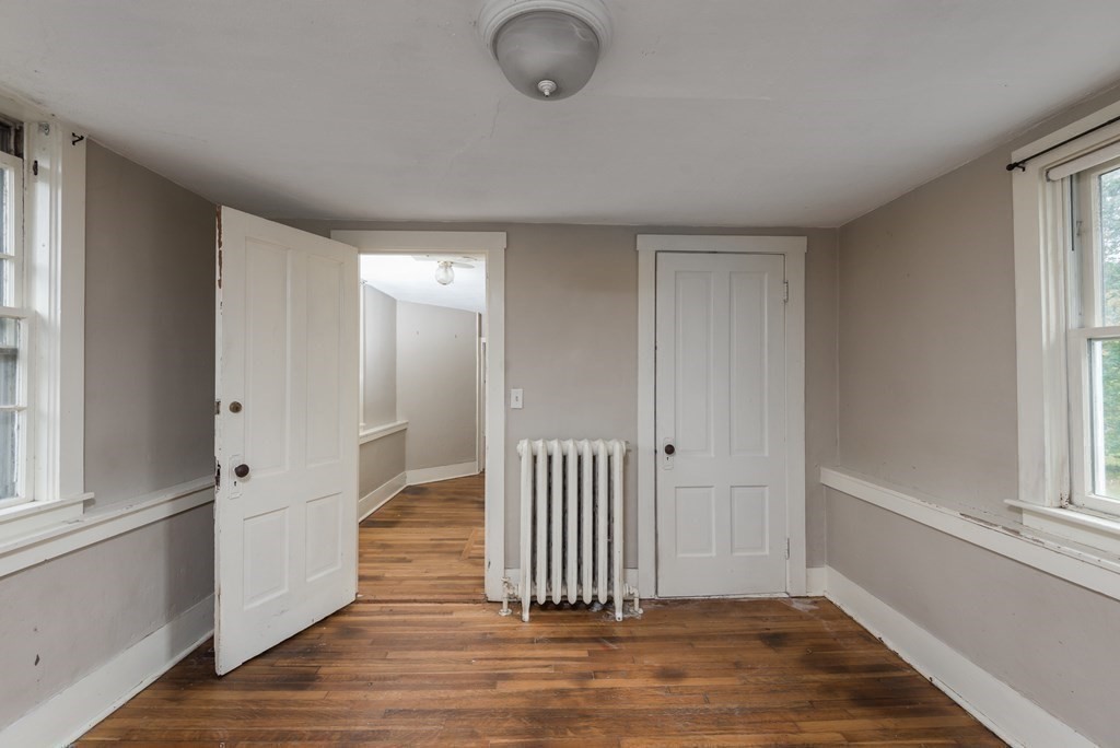 716 High Street Hanson, MA 02341 - Photo 15 of 21 an empty room with wooden floor and windows