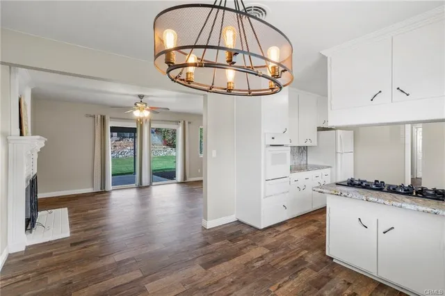 a kitchen with cabinets and a wooden floor