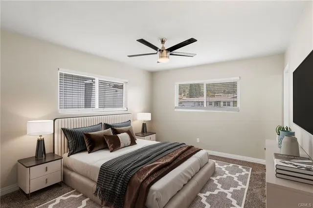 a bedroom with a bed and a tv