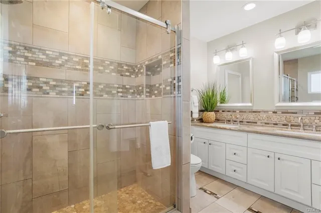a bathroom with a double vanity sink and mirror