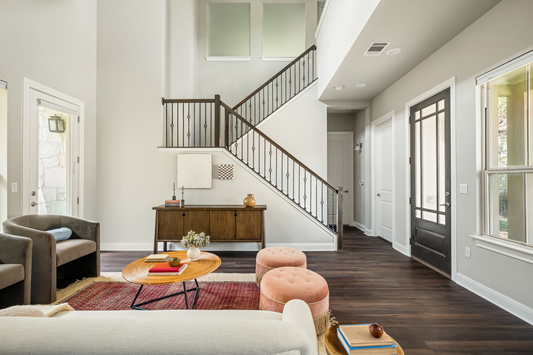2516 Hopsack Mills Road Austin, TX 78748 - Photo 2 of 39 Two-story foyer featuring a staircase with decorative wrought iron spindles and dark wood handrails
