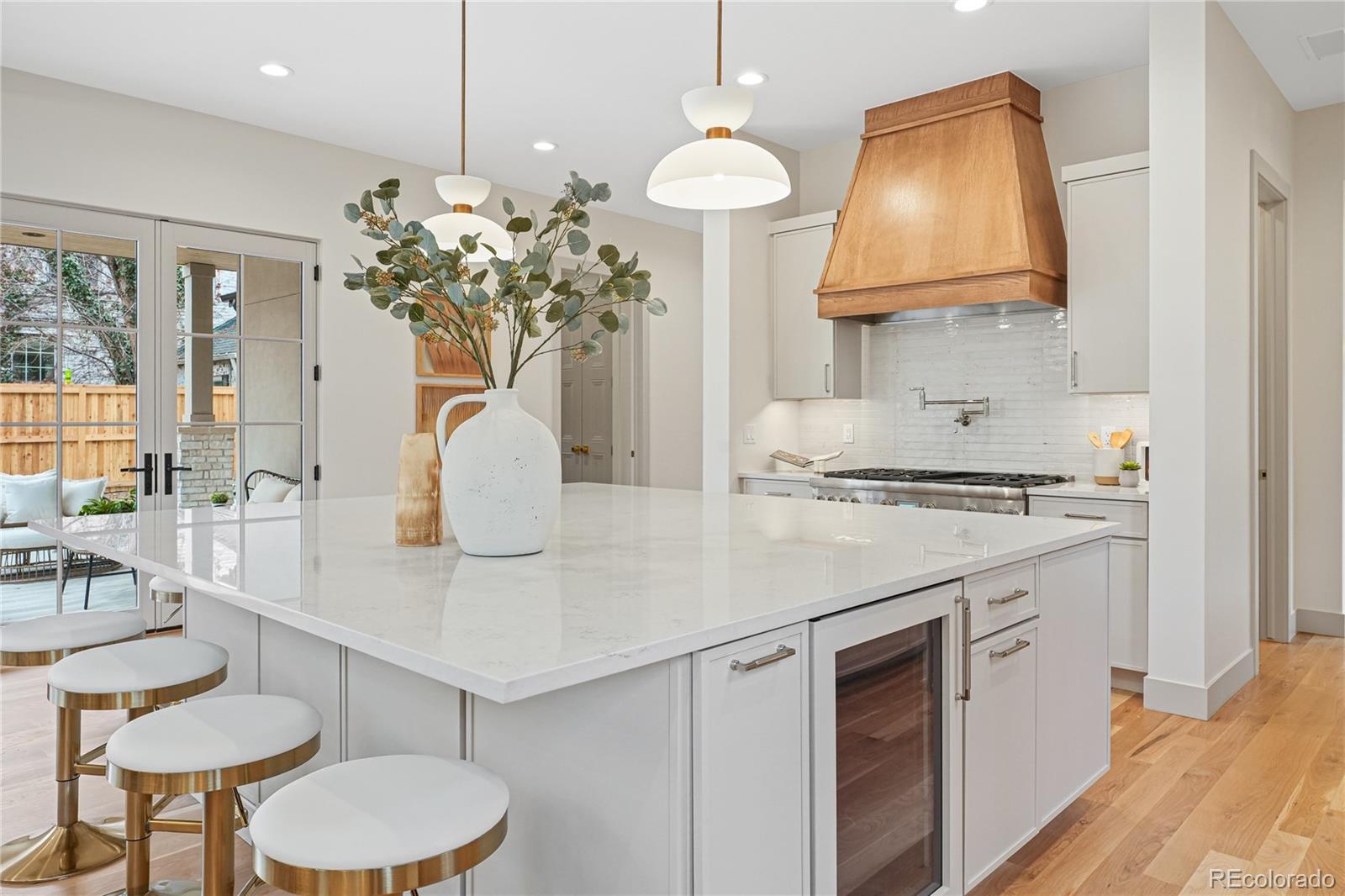 354 Cherry Street Denver, CO 80220 - Photo 12 of 44 a kitchen with stainless steel appliances granite countertop a sink a stove a dining table and chairs