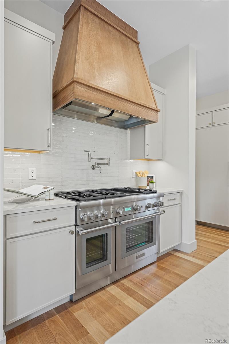 354 Cherry Street Denver, CO 80220 - Photo 13 of 44 a kitchen with stainless steel appliances granite countertop a stove and a microwave