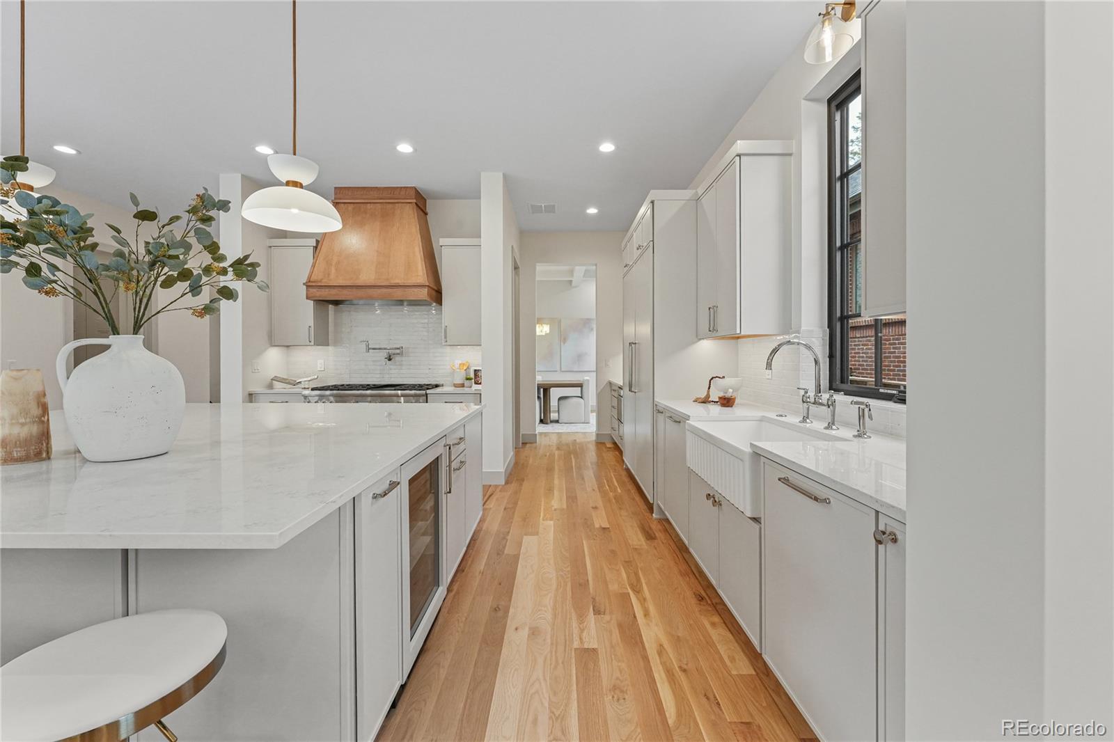 354 Cherry Street Denver, CO 80220 - Photo 14 of 44 a large kitchen with kitchen island a sink stainless steel appliances and a chandelier