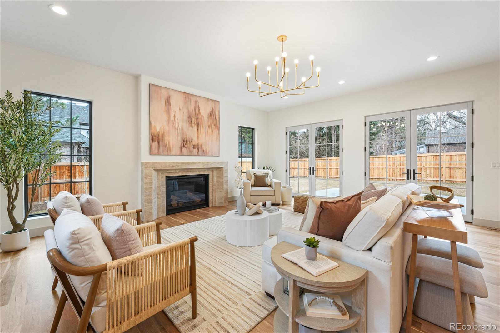 354 Cherry Street Denver, CO 80220 - Photo 17 of 44 a living room with furniture a chandelier and a fireplace