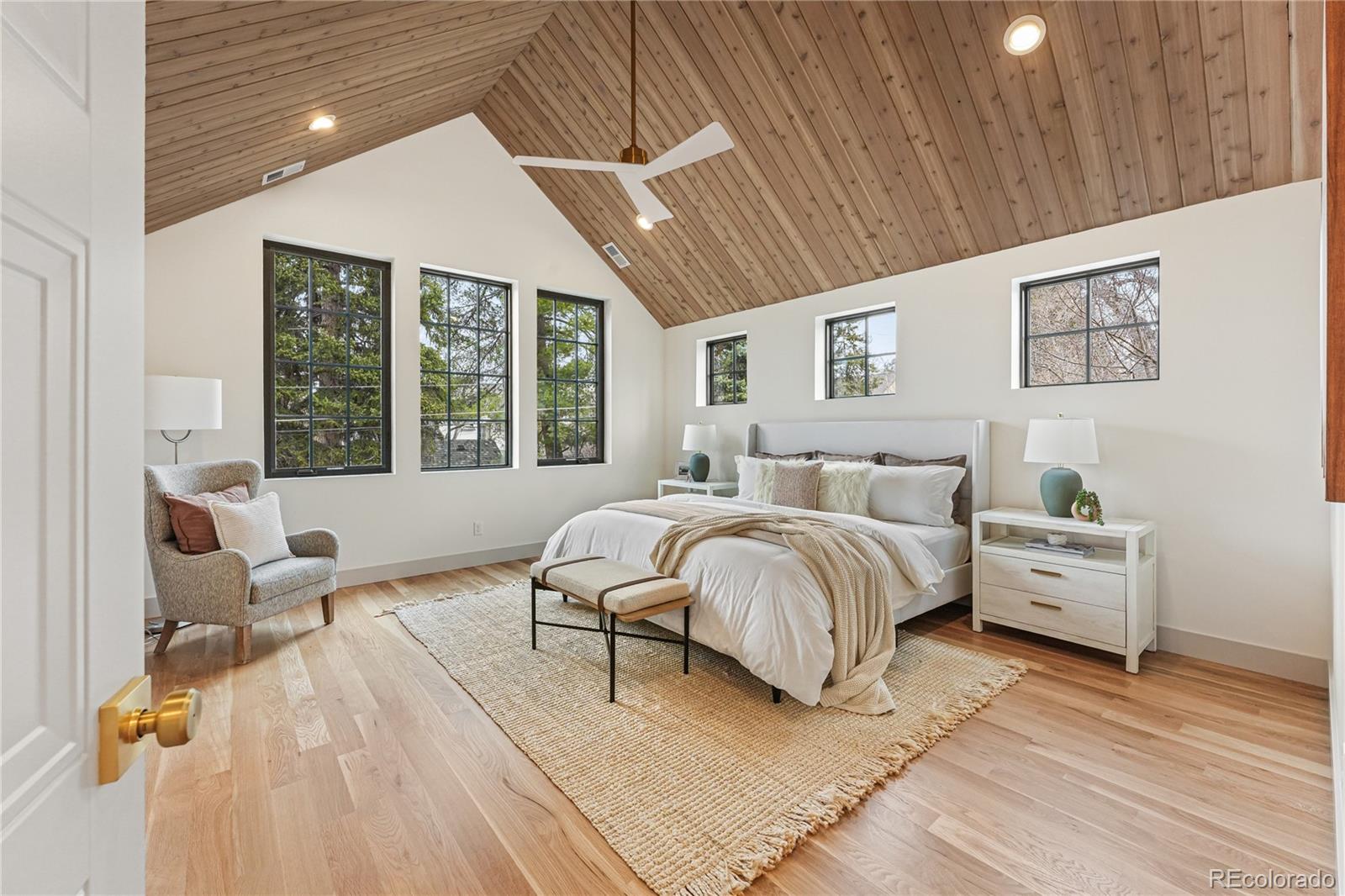 354 Cherry Street Denver, CO 80220 - Photo 26 of 44 a spacious bedroom with a bed couch and a large window