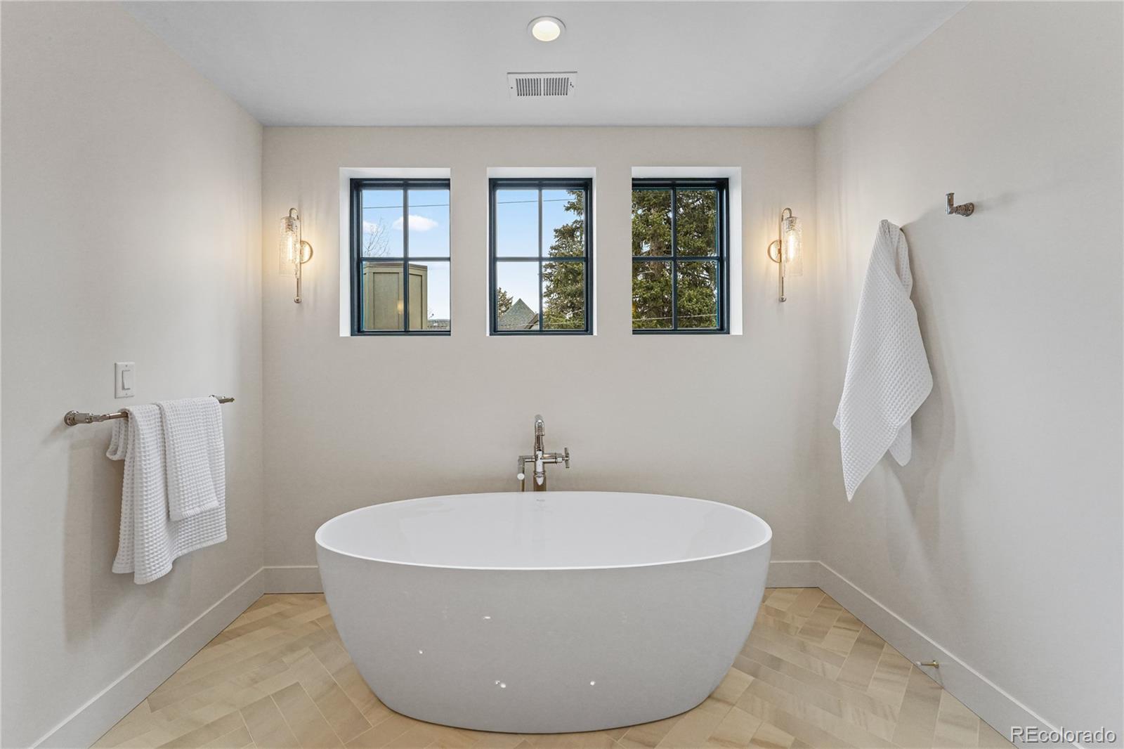 354 Cherry Street Denver, CO 80220 - Photo 30 of 44 a white bath tub sitting in a bathroom