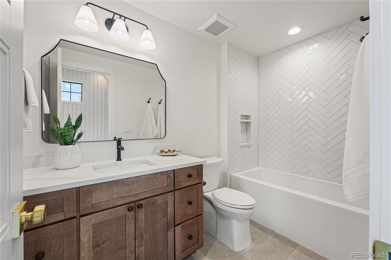 354 Cherry Street Denver, CO 80220 - Photo 37 of 44 a bathroom with a toilet a sink and a bathtub