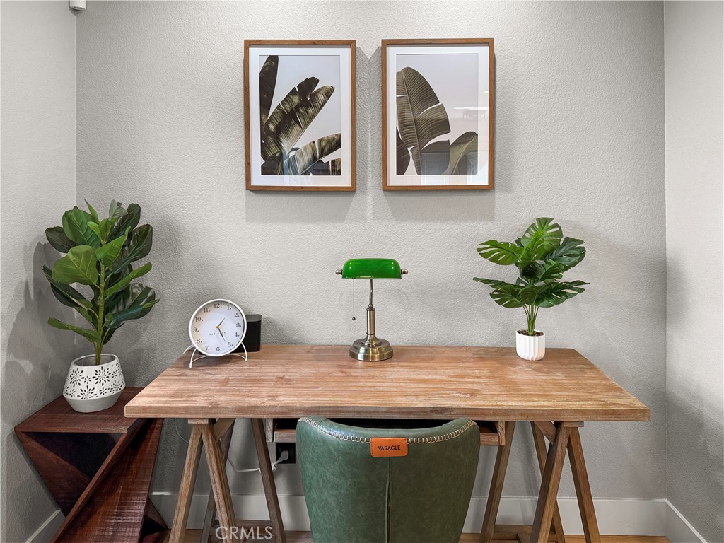 16955 Lake Knoll Parkway Riverside, CA 92503 - Photo 5 of 42 a table with a vase and flowers on it with wooden floor