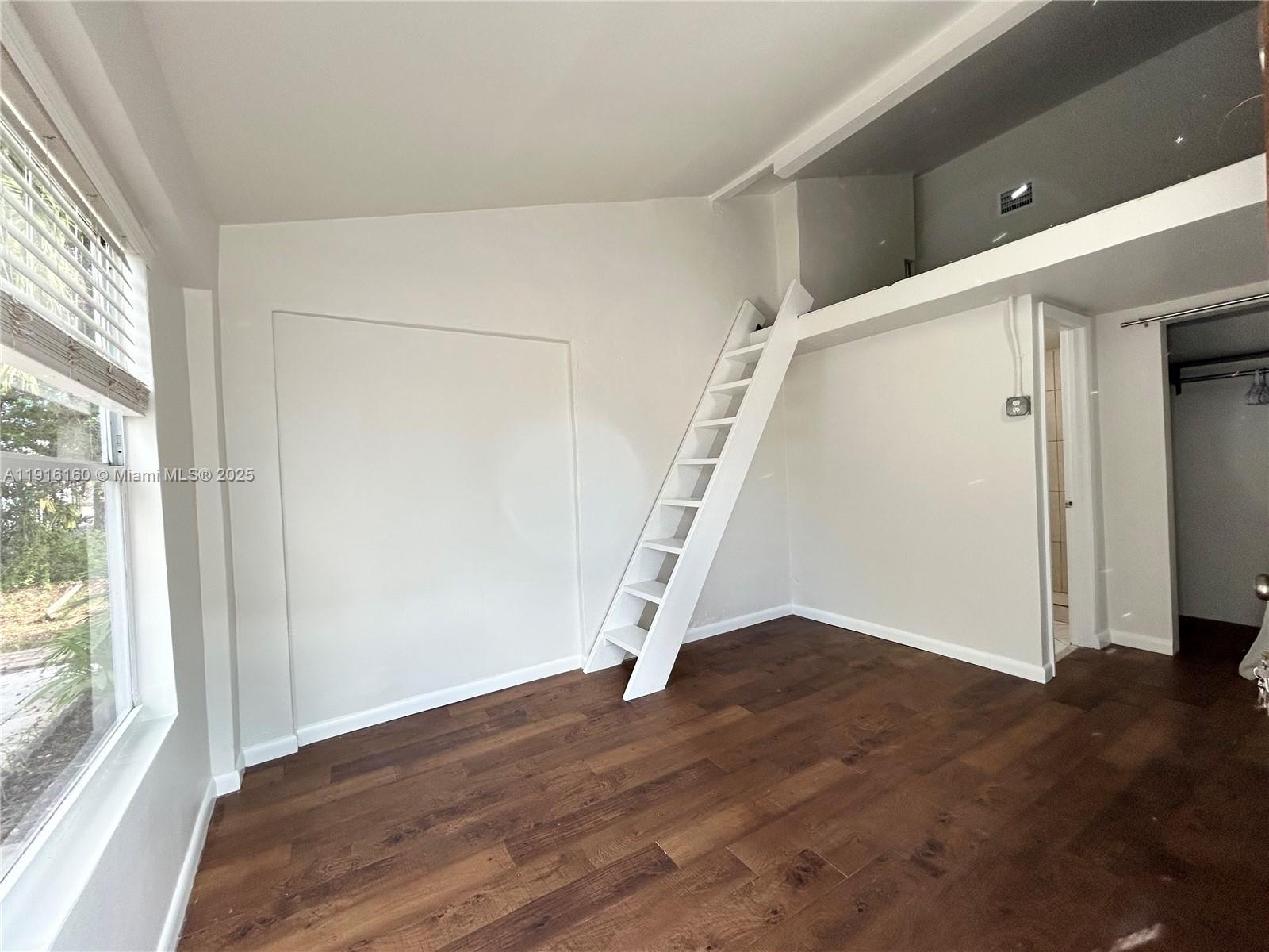 40 Northwest 39th Street, Unit 40 Miami, FL 33127 - Photo 15 of 17 wooden floor in an empty room with a window