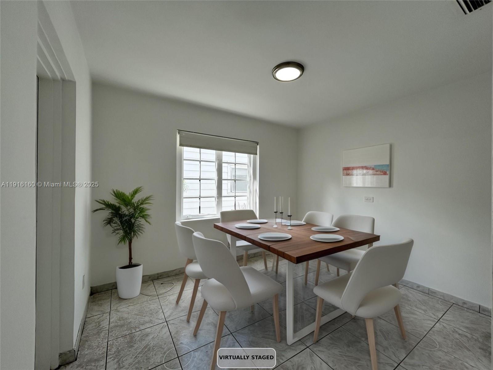 40 Northwest 39th Street, Unit 40 Miami, FL 33127 - Photo 5 of 17 a view of a dining room with furniture and a potted plant