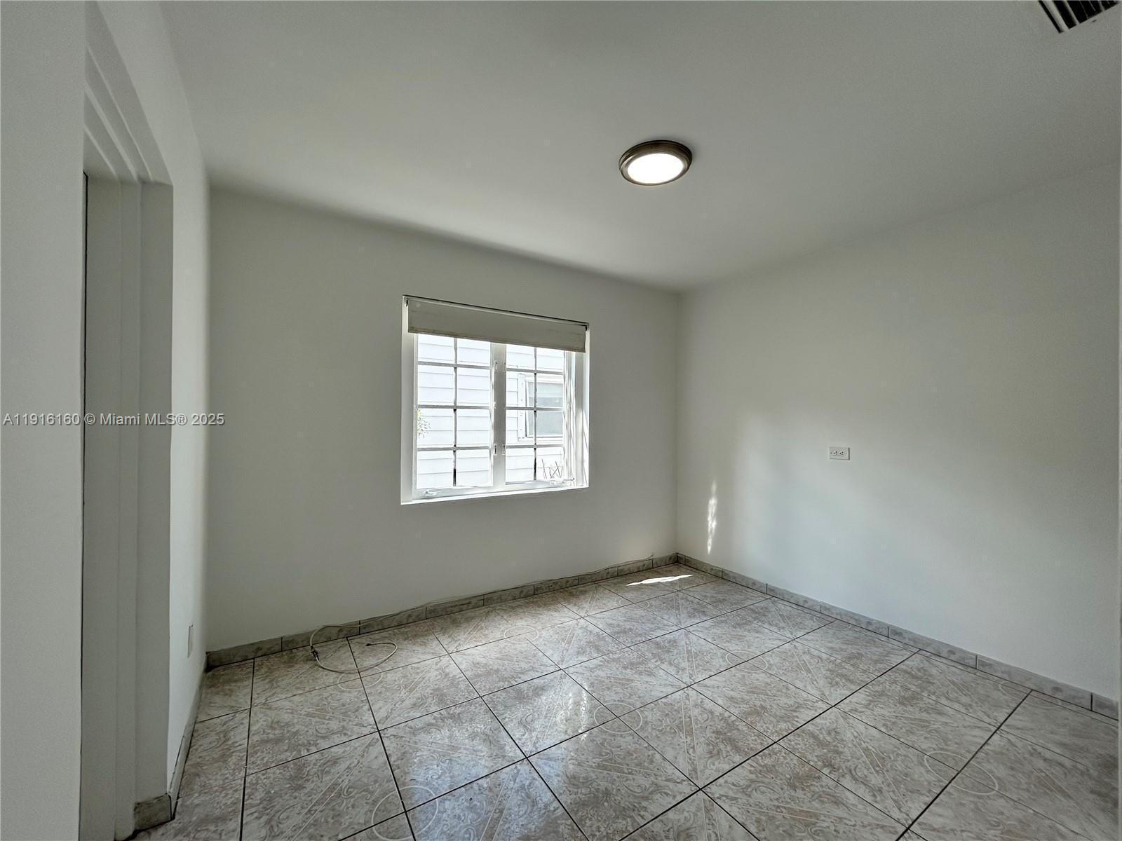 40 Northwest 39th Street, Unit 40 Miami, FL 33127 - Photo 6 of 17 a view of an empty room with a window