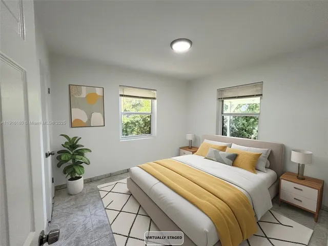 a bedroom with a potted plant and a window