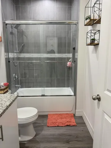a bathroom with a toilet and a shower