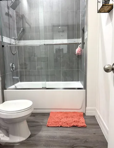 a bathroom with a toilet and a shower