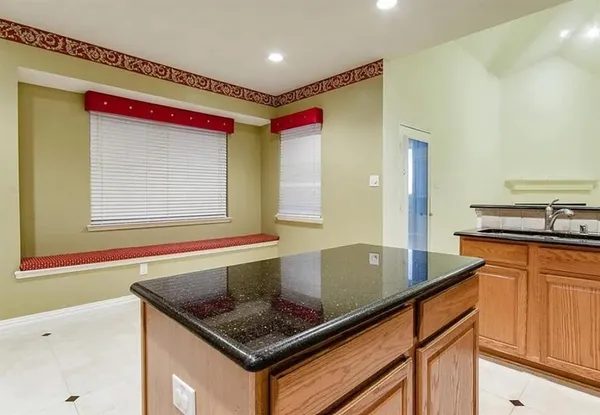a kitchen with stainless steel appliances granite countertop a sink and a microwave