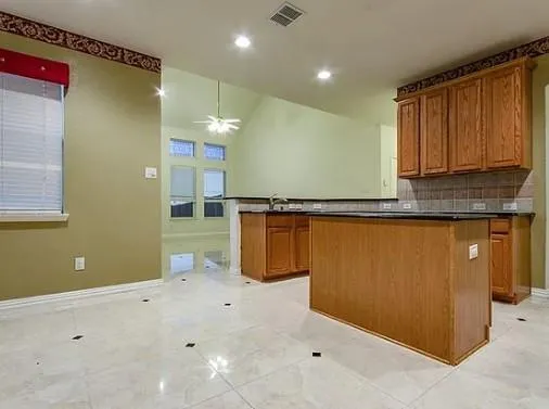 a view of a kitchen with microwave and cabinets