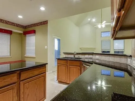 a large kitchen with kitchen island a sink stainless steel appliances and cabinets