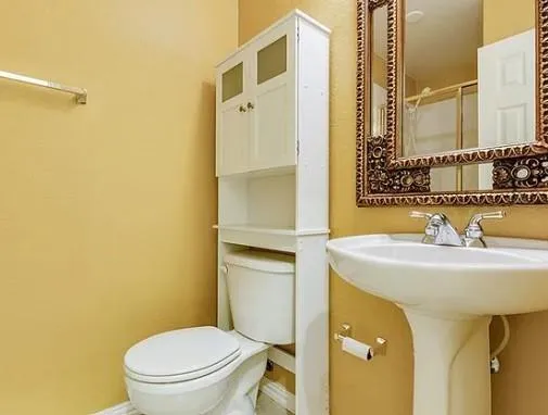 a bathroom with a sink toilet and mirror