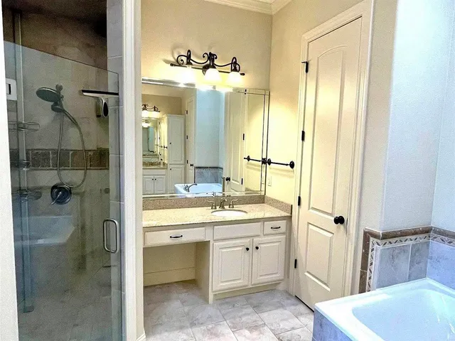 a bathroom with a double vanity sink mirror and shower