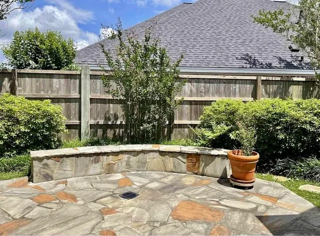 a view of a brick house with plants and plants