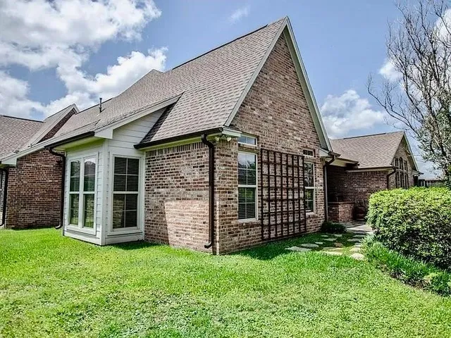 front view of a house with a garden