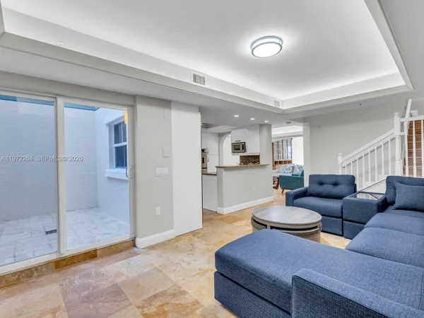a kitchen with stainless steel appliances granite countertop a sink refrigerator and microwave