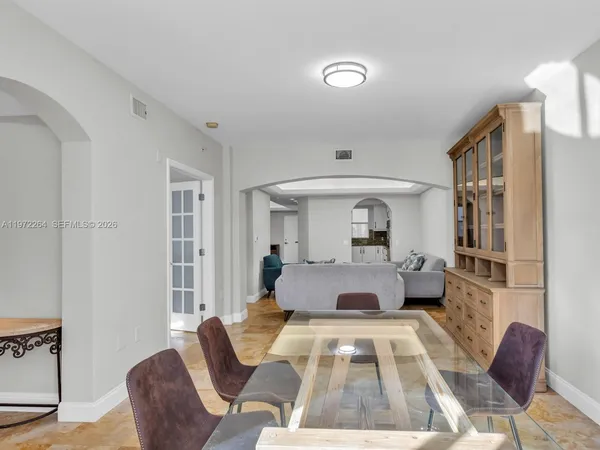 a view of kitchen with stainless steel appliances cabinets and outdoor space