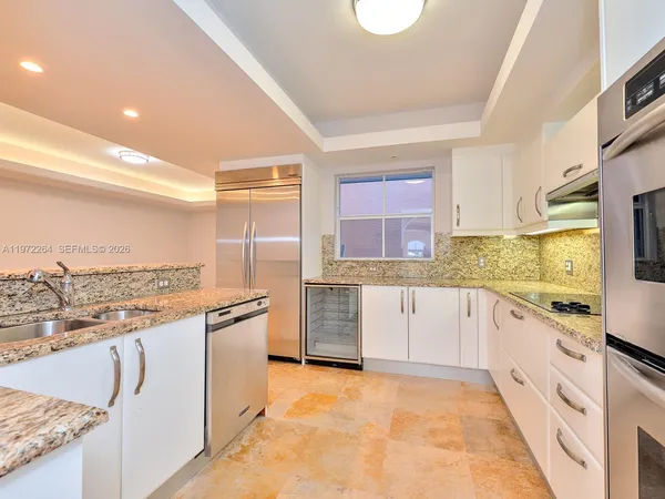 a spacious bedroom with a bed and a window