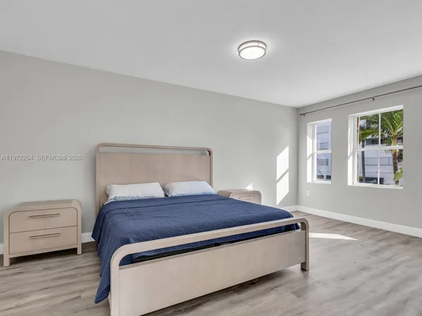 a view of a livingroom with wooden floor and window