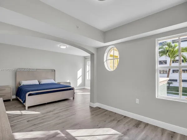 a spacious bathroom with a tub sink and mirror