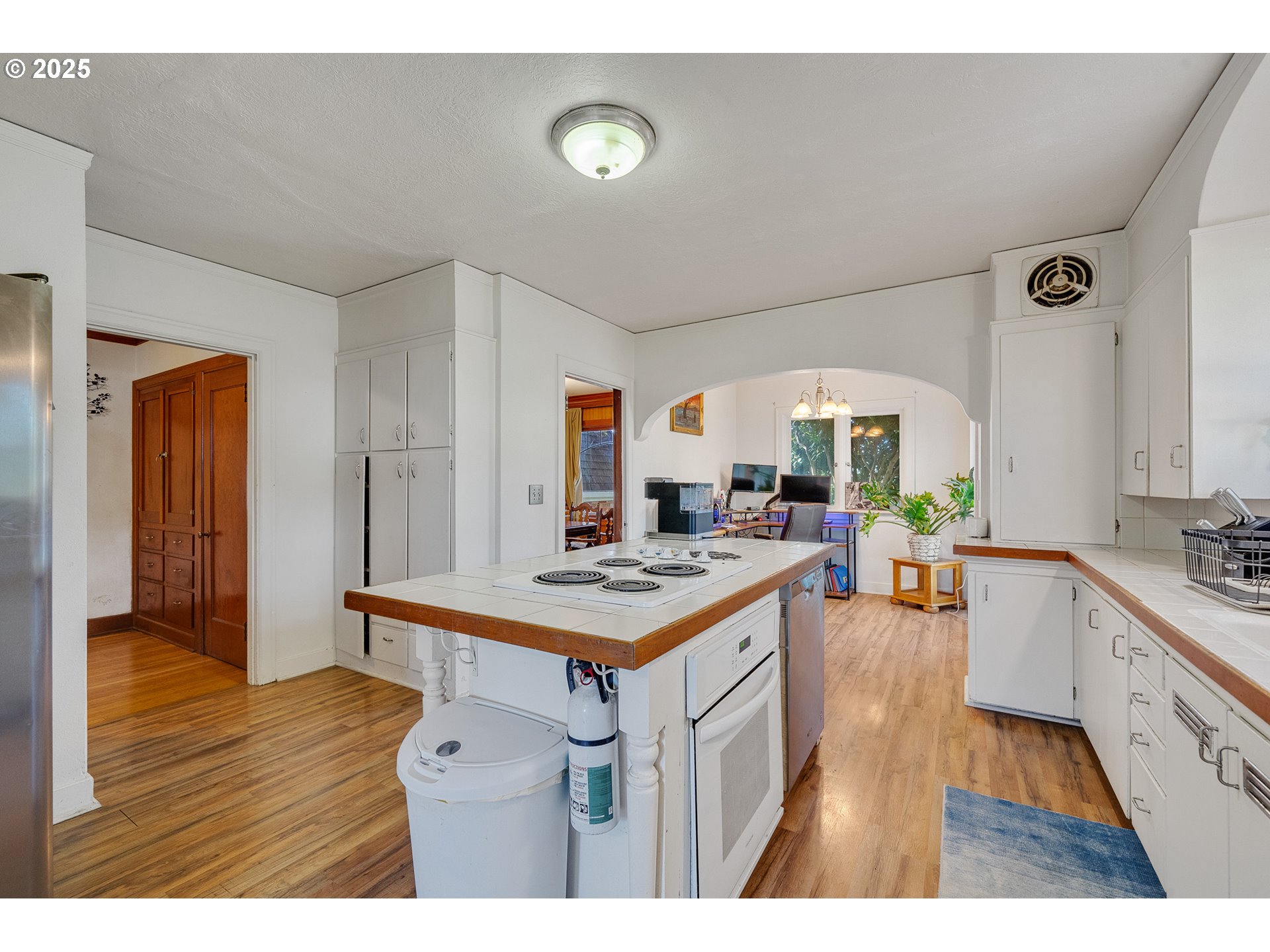 1703 4th Street Tillamook, OR 97141 - Photo 15 of 36 a open kitchen with a stove and a wooden floor