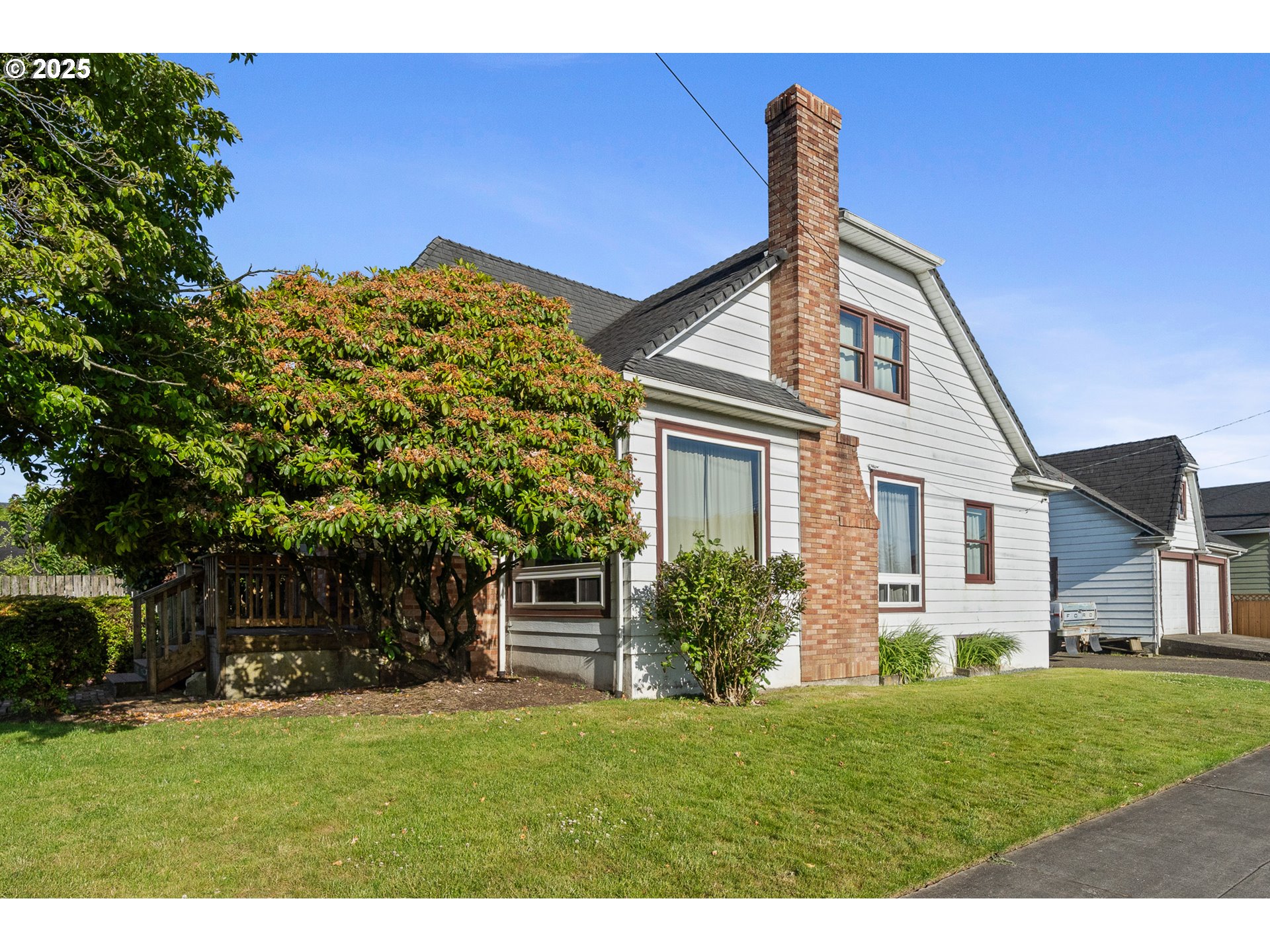 1703 4th Street Tillamook, OR 97141 - Photo 2 of 36 a front view of a house with a yard