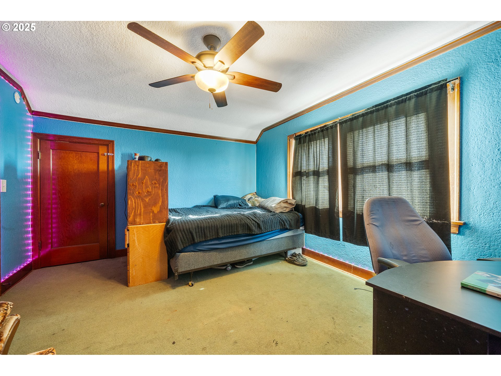 1703 4th Street Tillamook, OR 97141 - Photo 25 of 36 a bedroom with a large bed and a chandelier