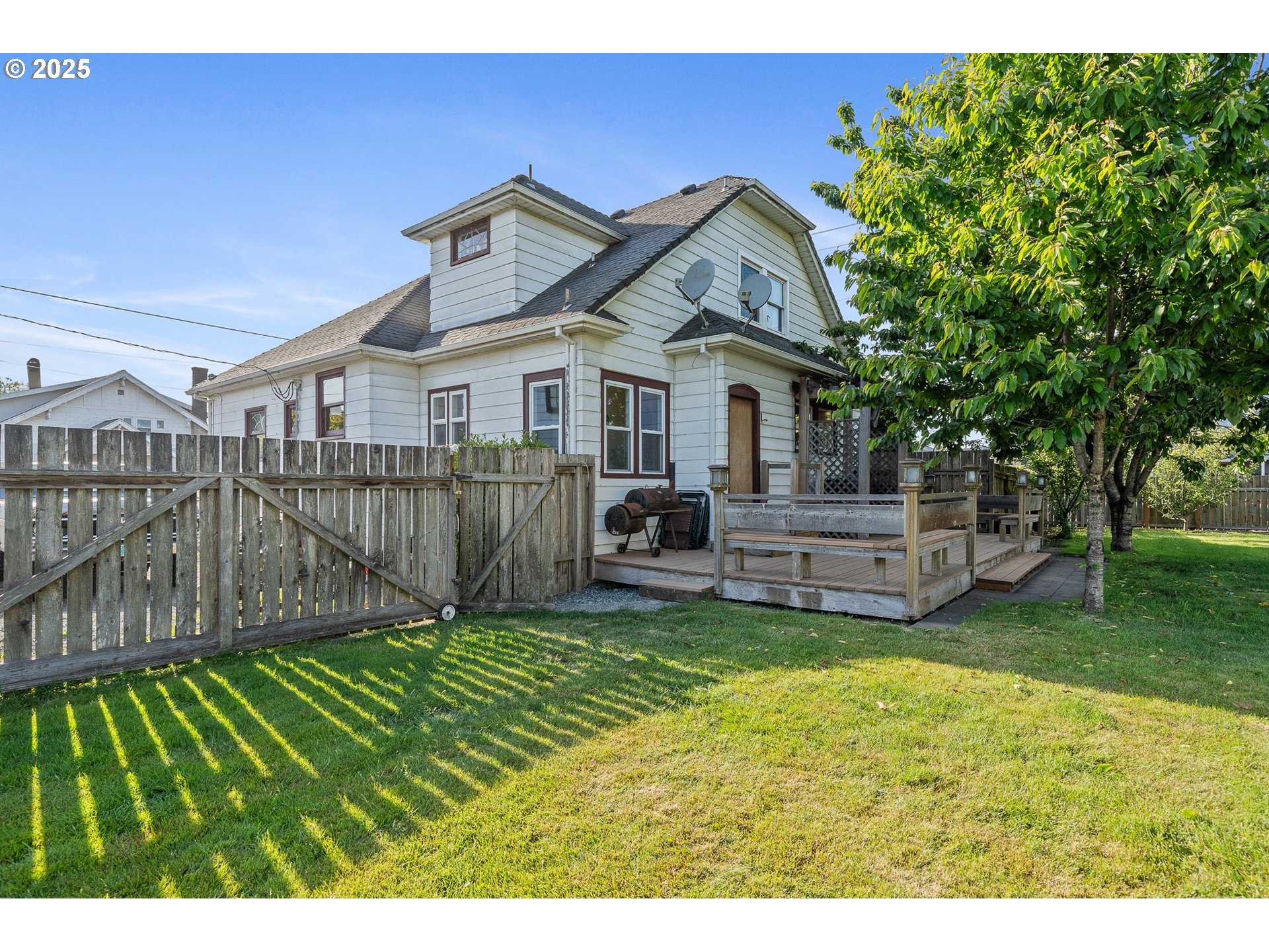 1703 4th Street Tillamook, OR 97141 - Photo 35 of 36 a view of a house with a big yard plants and large trees