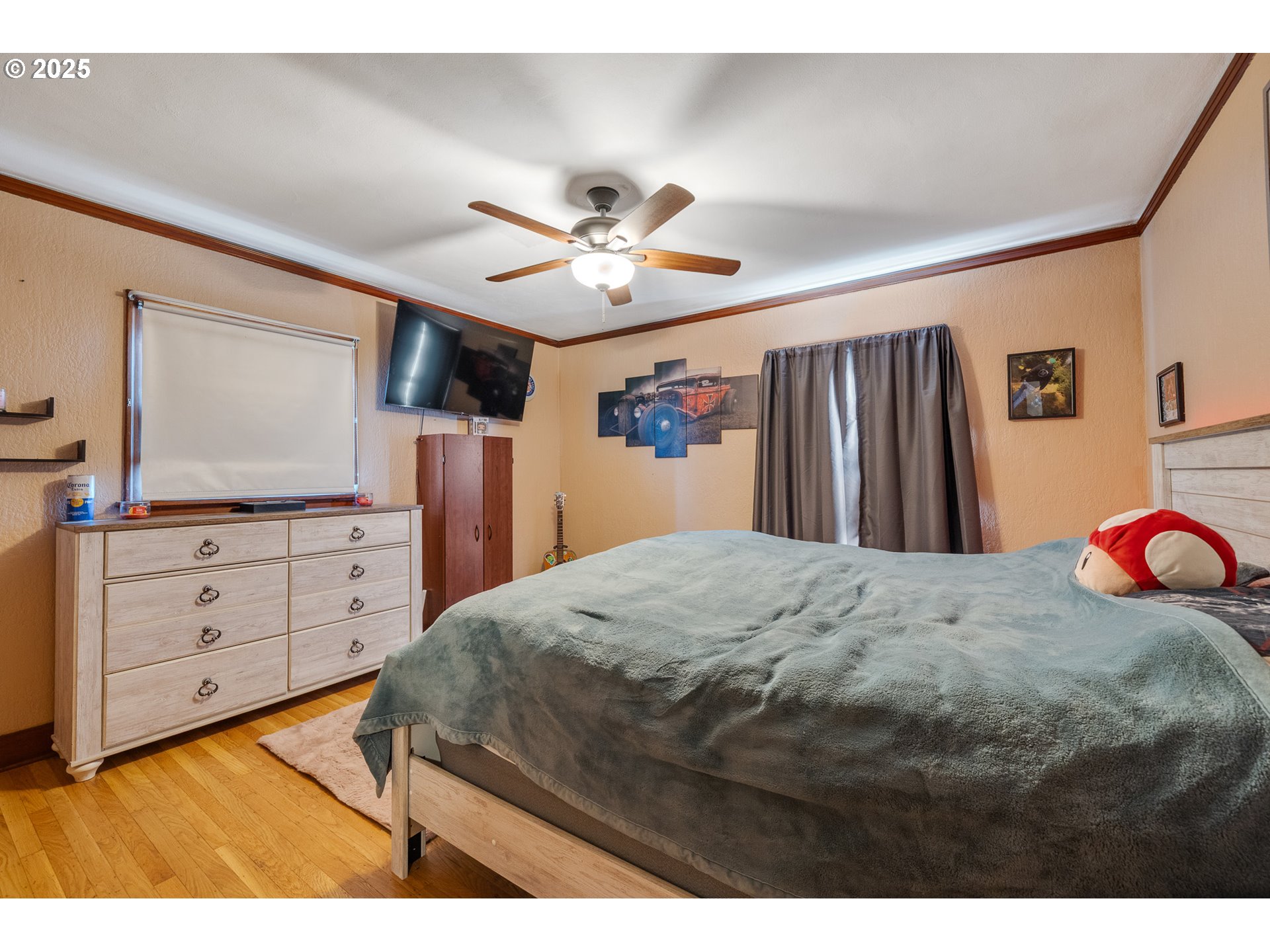 1703 4th Street Tillamook, OR 97141 - Photo 9 of 36 a bed room with a bed and a flat screen tv