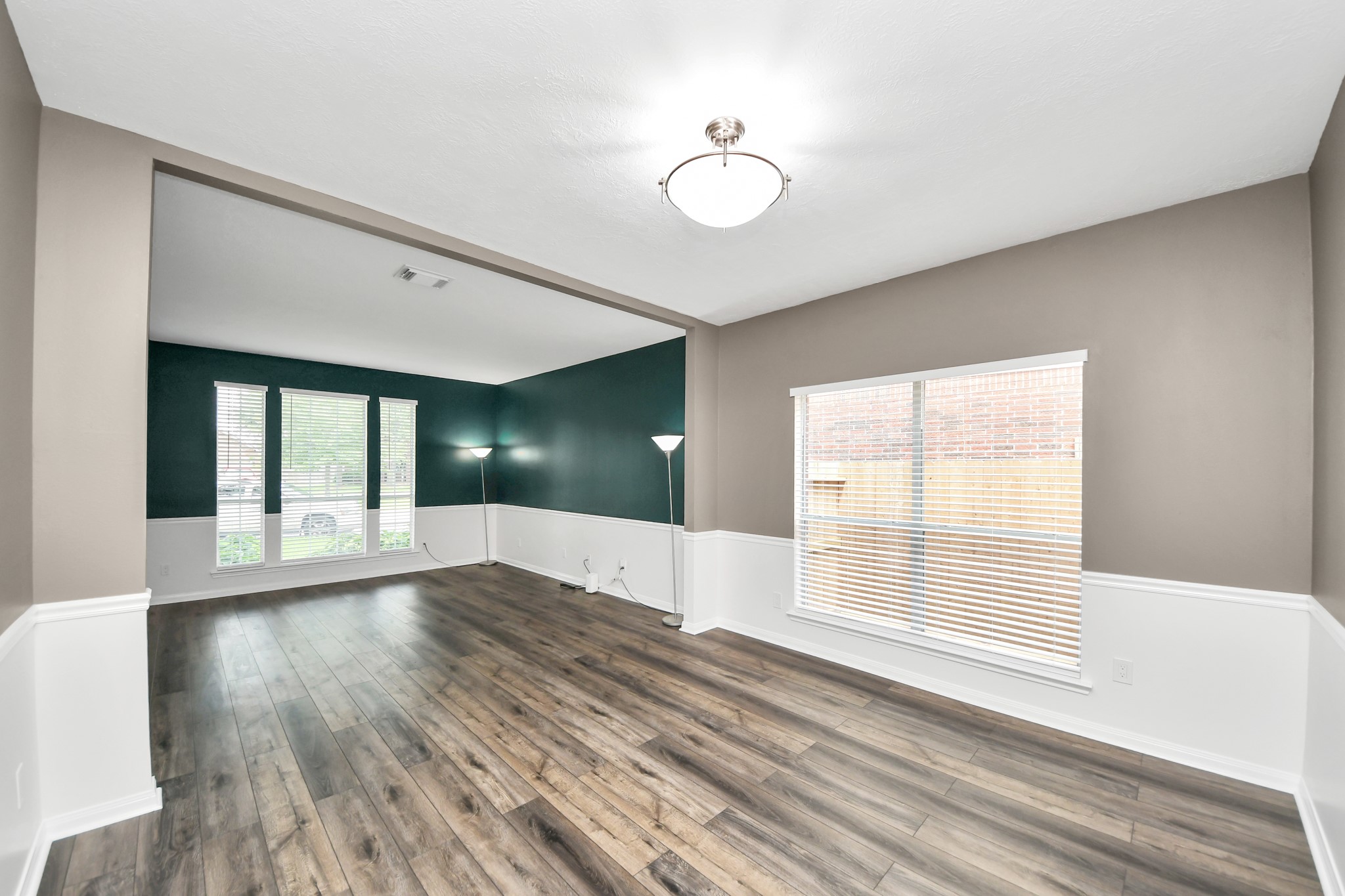 7622 McCormick Mill Court Houston, TX 77095 - Photo 13 of 37 a view of an empty room with wooden floor and a window