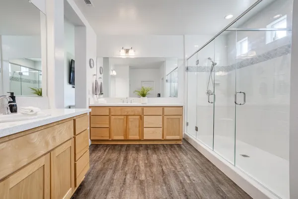 a bedroom with a bed a dresser and a window