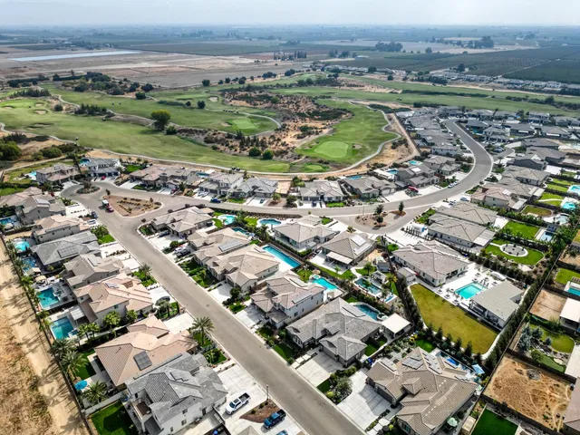 a view of a patio with a table and chairs under an umbrella