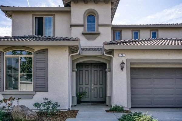 a kitchen with stainless steel appliances granite countertop a sink a stove and a refrigerator