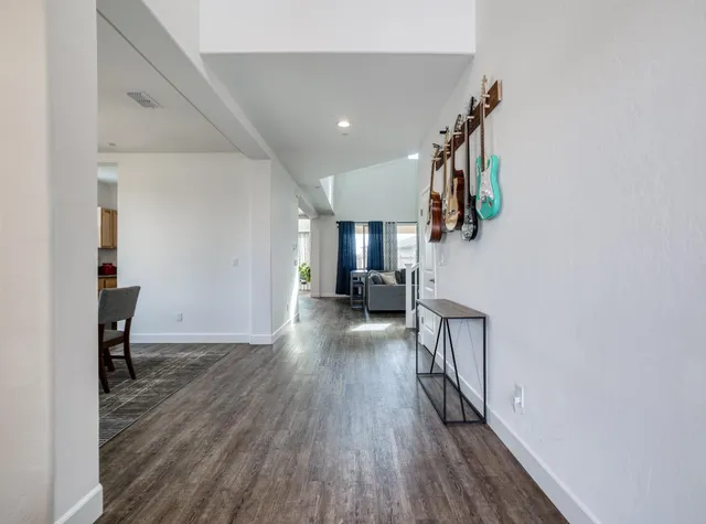a kitchen with stainless steel appliances granite countertop a stove a sink and white cabinets