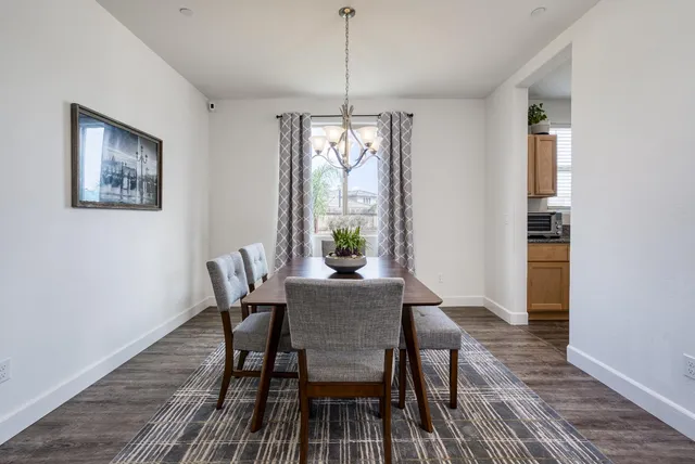 a kitchen with granite countertop a sink stove and wooden floor