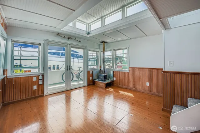 a view of a room with furniture wooden floor and windows