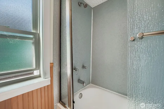 a bathroom with a tub and shower