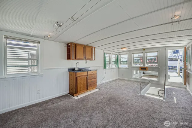 a view of a livingroom with furniture and a flat screen tv